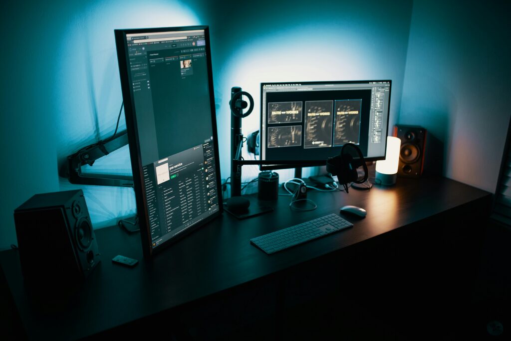 A contemporary office desk featuring a dual monitor setup with stylish lighting, ideal for tech enthusiasts.